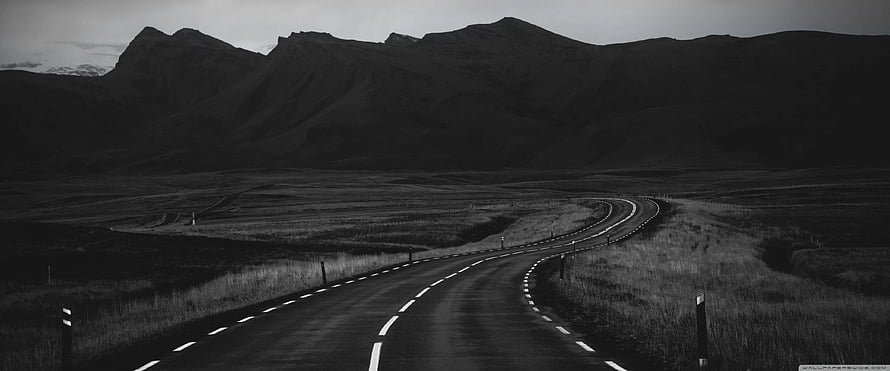 Monochrome Winding Road Through Vast Mountain Valley Landscape HD wallpaper