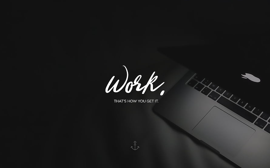 Minimalist Dark Laptop Workspace with Motivational Work Quote and Anchor Icon HD wallpaper
