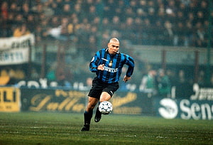 Ronaldo Nazario in Inter Milan Striped Kit Dribbling Ball on the Pitch HD wallpaper