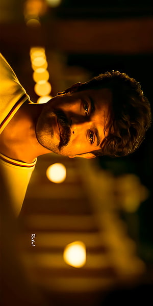 Ram Charan in RRR with warm bokeh lighting and cinematic portrait HD phone wallpaper