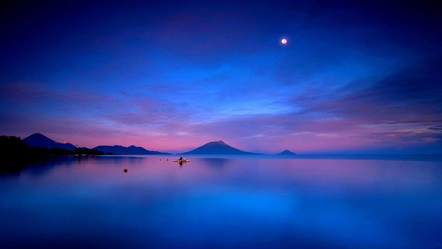 Serene Twilight Lake with Distant Volcanic Peaks and a Glowing Moon HD wallpaper