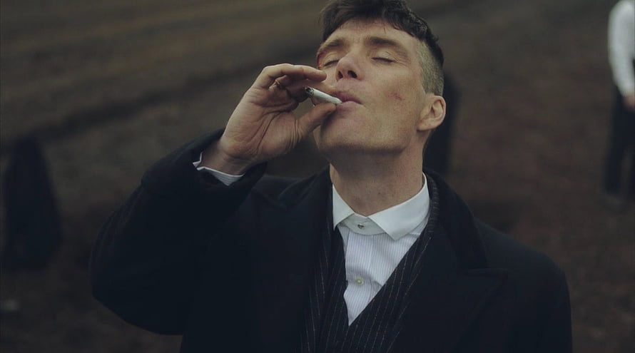 Cillian Murphy as Tommy Shelby smoking a cigarette in a dark coat HD wallpaper