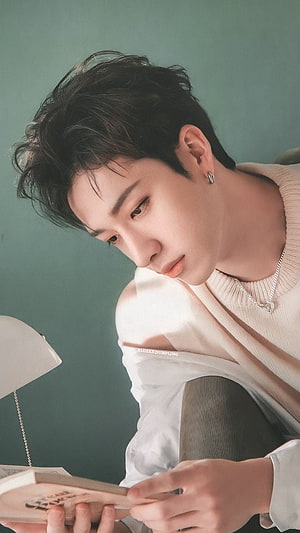 Bang Chan from Stray Kids Reading a Book in a Soft Beige Sweater HD phone wallpaper