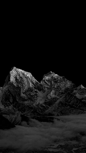 Dramatic Black and White Mountain Peaks Rising Above Thick Clouds HD phone wallpaper