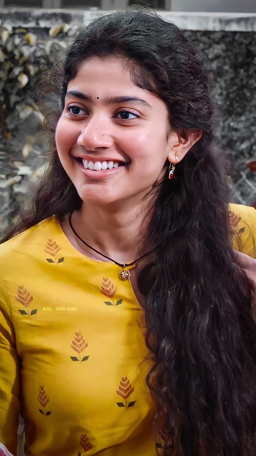 Sai Pallavi smiling portrait in yellow floral top with long wavy hair HD phone wallpaper