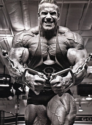Jay Cutler Performing Cable Crossover in Black and White Gym Portrait HD phone wallpaper