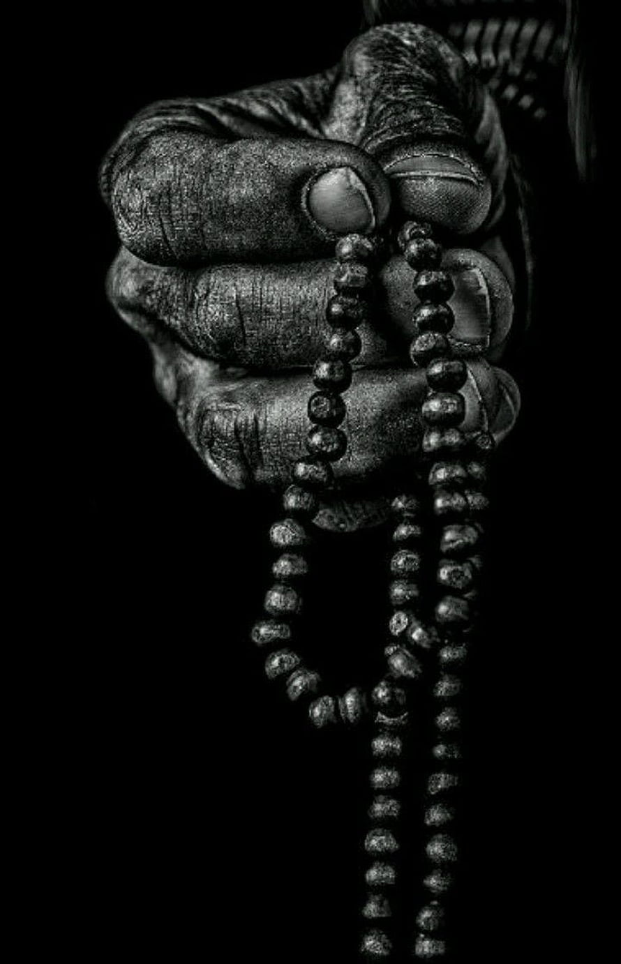 Weathered Hand Gripping Prayer Beads in Dramatic Black and White Photography HD phone wallpaper