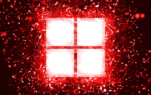 Glowing Red Microsoft Windows Logo Set Against a Fiery Particle Explosion Background HD wallpaper
