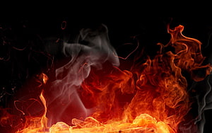 Intense Flames and Swirling Smoke Rising Against a Dark Background HD wallpaper