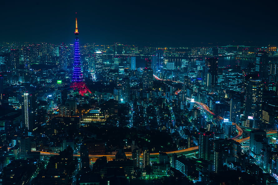 Tokyo Tower Illuminated in Neon Colors Over Night Cityscape HD wallpaper