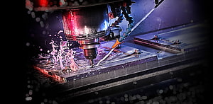 CNC Milling Machine in Action with Coolant Spray and Metal Cutting HD wallpaper