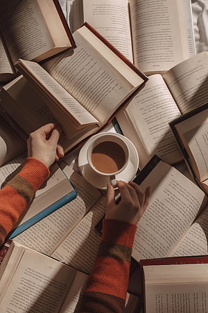 Cozy Reading Scene with Open Books and a Warm Cup of Coffee HD phone wallpaper