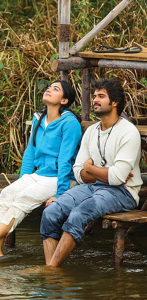 Dhanush and Sai Pallavi sitting on a wooden dock in the movie Kaaka Muttai HD phone wallpaper