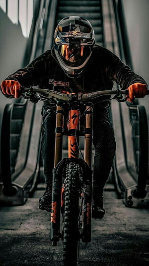 Downhill Mountain Biker in Full Protective Gear Riding an Orange Fox Bike HD phone wallpaper