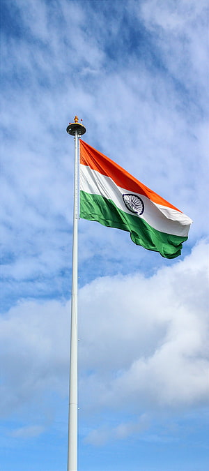 Indian National Flag Waving High on a Tall Pole Against a Blue Sky HD phone wallpaper