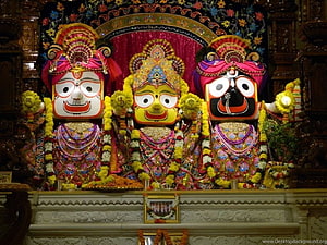 Lord Jagannath and Brothers in Ornate Temple Setting with Vibrant Garlands HD wallpaper