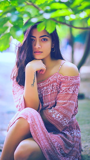 Woman in Pink Patterned Dress Sitting Under Green Leaves, Rashmika Mandanna, South, Actress HD phone wallpaper