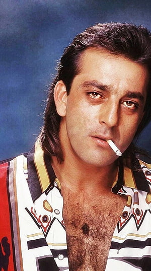 Sanjay Dutt Portrait in Patterned Shirt with Cigarette Against Blue Background HD phone wallpaper