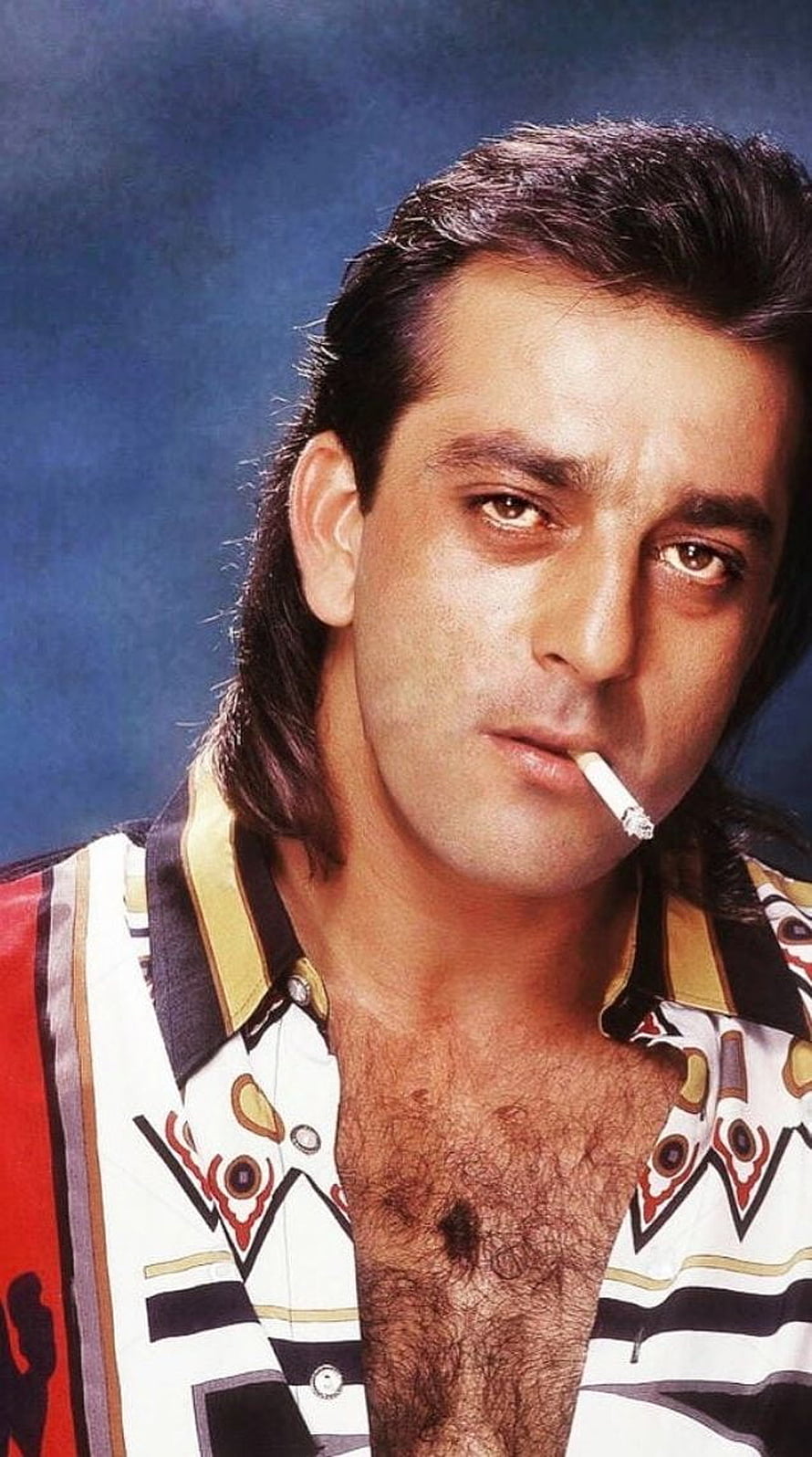Sanjay Dutt Portrait in Patterned Shirt with Cigarette Against Blue Background HD phone wallpaper