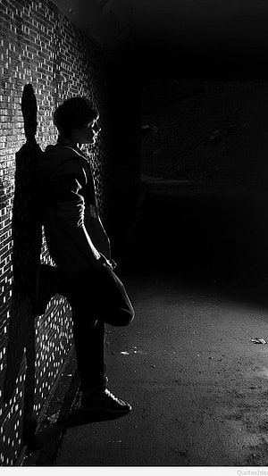 Moody Black and White Portrait of a Young Man Leaning Against a Brick Wall in a Dark Alley, Sad Alone Boy With Quotes Background, Boy Pic HD phone wallpaper