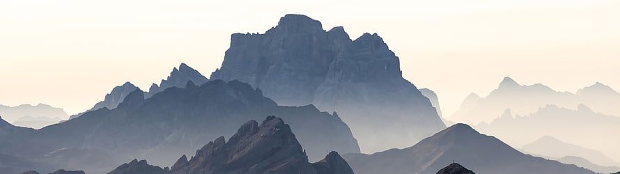 Misty Mountain Ranges at Dawn with Layered Peaks and Soft Morning Light HD wallpaper
