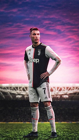 Cristiano Ronaldo in Juventus Kit Standing on the Pitch Under a Vibrant Pink Sky HD phone wallpaper