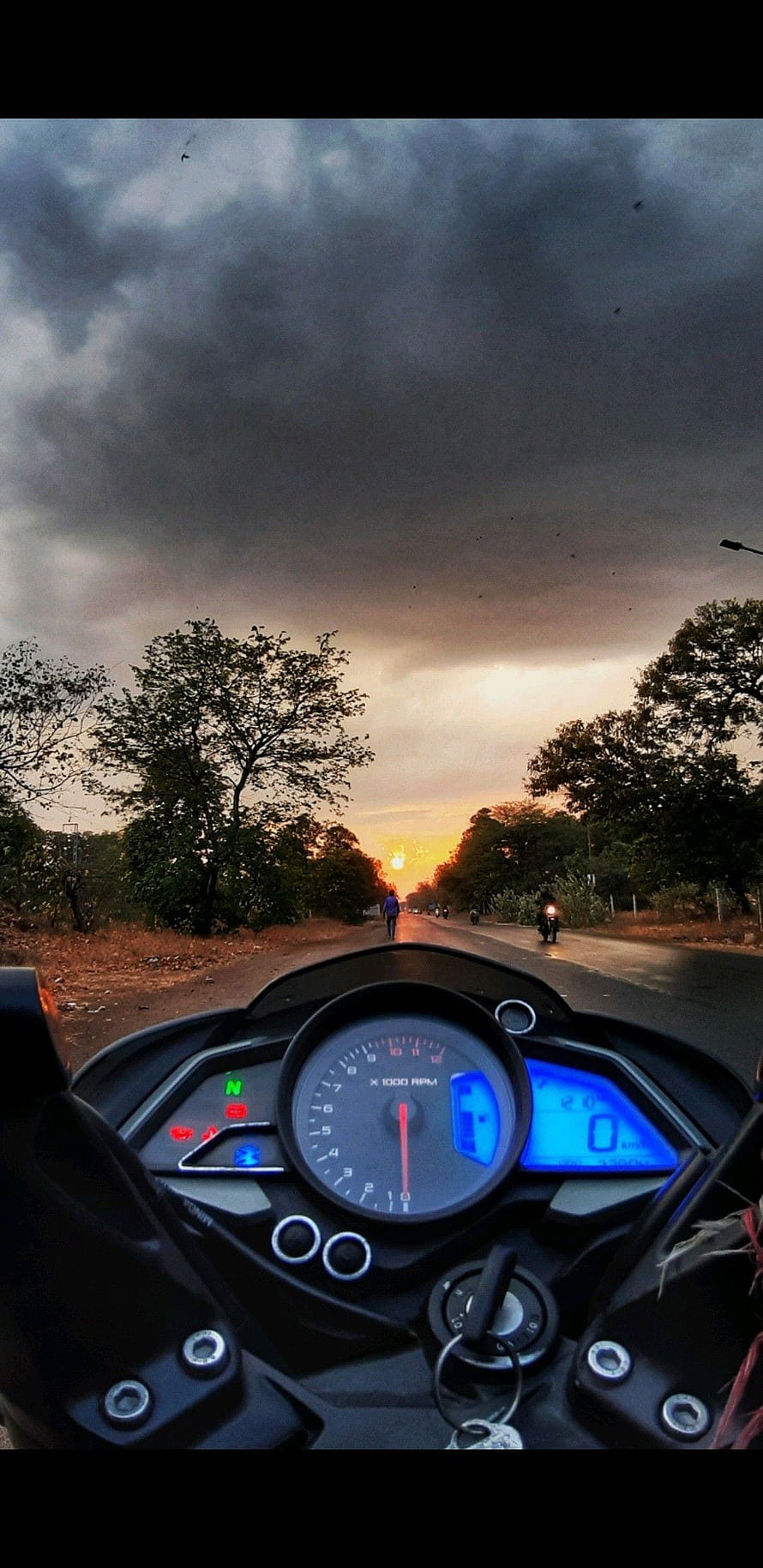 NS 200 Motorcycle Dashboard View on a Rural Road at Sunset HD phone wallpaper