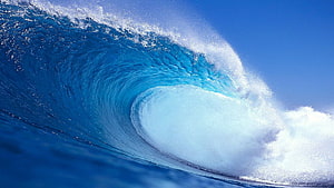 Majestic Ocean Wave Curling Into A Perfect Barrel Under A Clear Blue Sky HD wallpaper