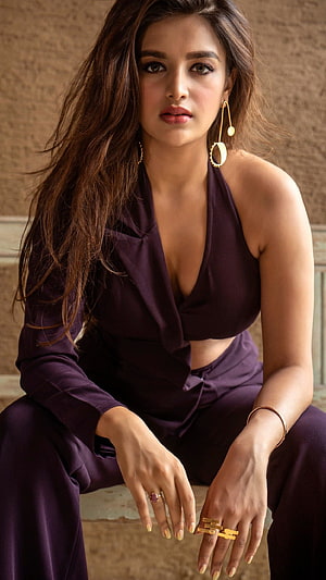 Niddhi Agarwal in a deep purple halter top and matching trousers with gold jewelry HD phone wallpaper