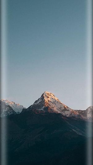 Majestic Snow-Capped Mountain Peak at Sunrise with Golden Hour Light HD phone wallpaper