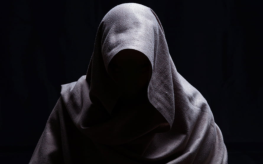 Anonymous figure in a dark hooded cloak against a black background HD wallpaper