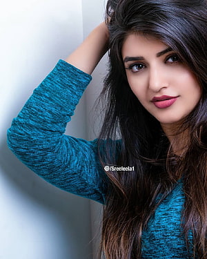 Sreeleela Portrait in Teal Knit Top with Long Dark Hair HD phone wallpaper