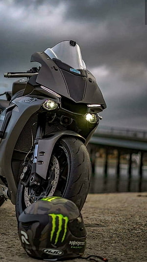 Matte Black Yamaha R1 Motorcycle with Monster Energy Helmet on Pier HD phone wallpaper