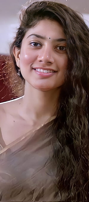 Portrait of Indian Actress Kajol Smiling with Long Wavy Hair and Traditional Saree HD phone wallpaper