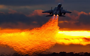 Fighter Jet with Afterburners Ignited Against a Dramatic Sunset Sky HD wallpaper