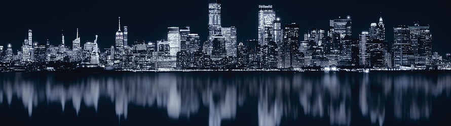 New York City Skyline at Night with Water Reflections in Cool Blue Tones HD wallpaper