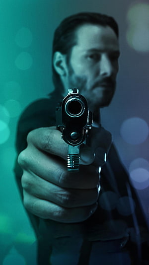 John Wick Aiming Pistol in Cinematic Teal and Blue Lighting HD phone wallpaper