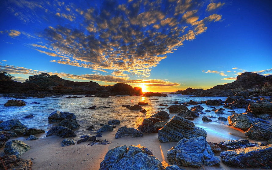 Stunning Sunset Over Rocky Beach With Golden Clouds And Ocean Waves HD wallpaper