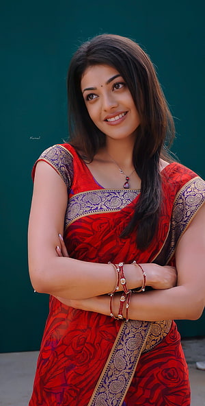 Kajal Aggarwal in a red floral sari with gold border and traditional jewelry HD phone wallpaper