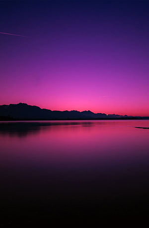 Vibrant Purple and Pink Sunset Over Calm Lake With Mountain Silhouette HD phone wallpaper