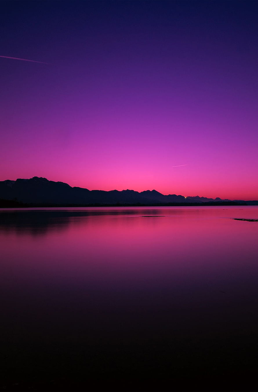 Vibrant Purple and Pink Sunset Over Calm Lake With Mountain Silhouette HD phone wallpaper