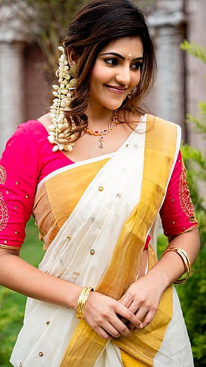 Athulya Ravi in a Traditional White and Gold Saree with Floral Hair Accessory HD phone wallpaper