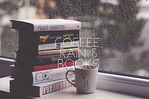 Cozy stack of books and coffee mug on a rainy window sill HD wallpaper