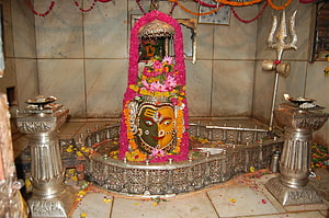 Sacred Hindu Temple Shrine Featuring Decorated Deity Idol With Trishul And Oil Lamps HD wallpaper