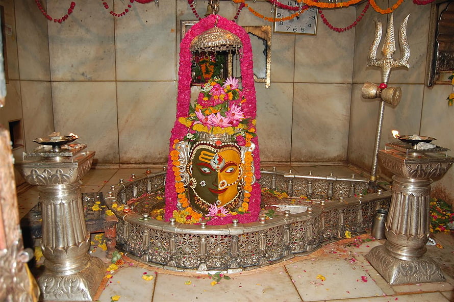 Sacred Hindu Temple Shrine Featuring Decorated Deity Idol With Trishul And Oil Lamps HD wallpaper