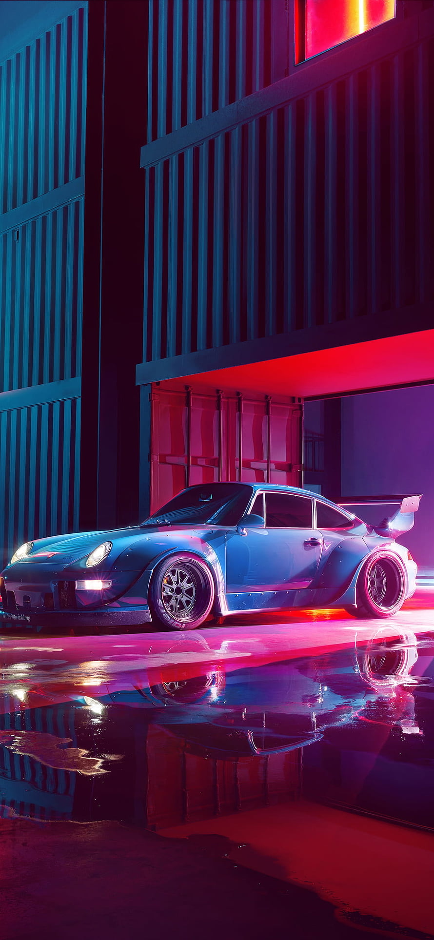 Blue Porsche 911 Widebody in Neon Lit Industrial Garage with Wet Floor Reflections HD phone wallpaper