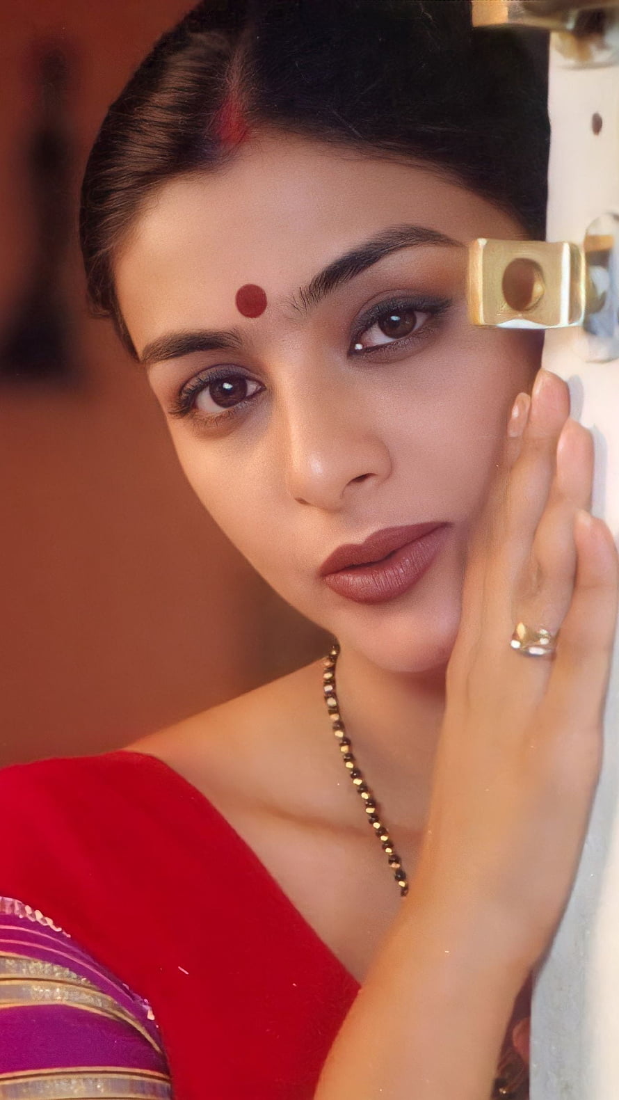 Tabu in a red sari with bindi and gold jewelry in a vintage Bollywood portrait HD phone wallpaper
