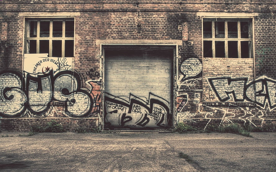 Urban Decay: Weathered Brick Wall Covered in Street Art and Graffiti Tags HD wallpaper