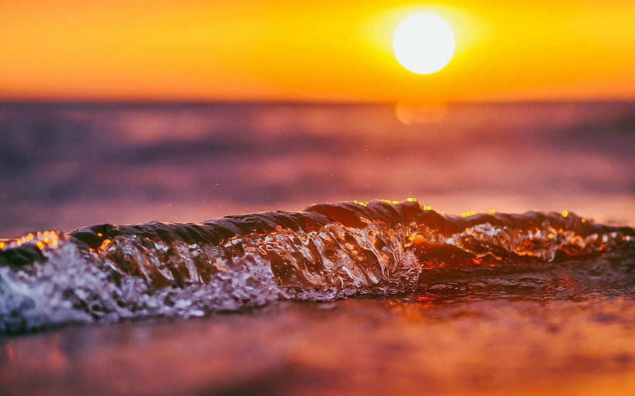 Golden Ocean Sunset with Breaking Waves and Glowing Horizon HD wallpaper