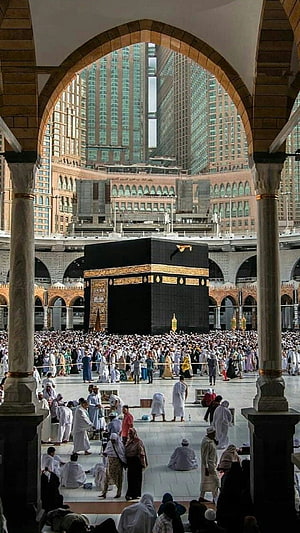 Kaaba in Mecca Mosque with Pilgrims and Modern Skyscrapers HD phone wallpaper